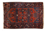 Vintage Borchalou rug with a geometric vase design in madder rust red and sapphire blue with boteh borders.