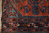 Detail of the vintage Borchalou's boteh border and floral corner in madder rust and sapphire blue.