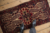 Antique Mohajeran Sarouk rug with rare serpent design border and ruby red floral elements.