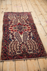 Antique Mohajeran Sarouk runner close-up: ivory field, ruby red floral bouquet, navy serpent border.