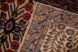 Hand-knotted back weave showing navy blue, ruby red, ivory pattern, and floral pile.
