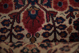Textured pile of antique Mohajeran Sarouk rug, ruby red florals, navy blue, and rare ivory ground.