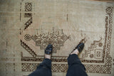 A view from above showing the soft, even wear and low-pile texture of a distressed Oushak rug.