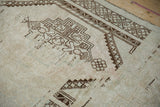 Even wear to knot heads on a distressed Oushak rug showing brown motifs and pale blush abrashes.