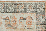 Distressed vintage Oushak rug detail showing ivory, rust, and brown patterns with visible knot wear.