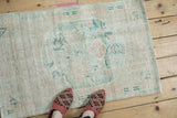 Faded floral bouquet and worn texture of the vintage distressed Oushak rug pile.