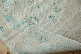 Hand-knotted foundation and worn pile of the vintage Oushak rug with visible selvage.