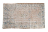 Distressed Vintage Turkish Sparta rug with faded pale blue prayer design on a sandy field.
