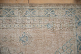 Distressed vintage Sparta rug with worn pile, visible knot heads, and pale sky blue accents.