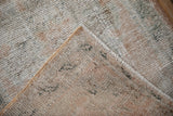 Hand-knotted foundation and secured selvage of distressed Oushak rug, showing worn pile.