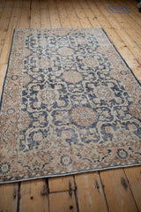 Distressed navy blue and pale coral Sparta rug, showing pomegranate, leaf, and vine details.