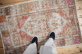 A view from above showing the scale and time-worn texture of a distressed Oushak rug.