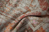Close view of the worn pile and exposed foundation on a distressed hand-knotted Turkish Oushak rug.