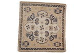 Distressed vintage Oushak square rug with a shield medallion and florals in beige, navy, and bronze.