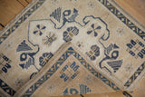 Folded corner of a vintage Oushak rug revealing its detailed hand-knotted back.