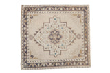 Vintage distressed Oushak square rug with an oversized center medallion in cream, beige, and brown.
