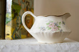 Delicate crazing and floral details on the side of the Homer Laughlin creamer.