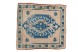 Distressed Oushak square rug with pale sapphire blue stepped medallion on an ivory ground.