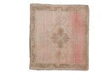 Vintage distressed Oushak square rug with a central medallion on an abrashed field of blush pink and sand.