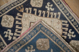 Distressed Oushak rug's navy blue, ivory, and bronze pattern with hand knotted reverse.