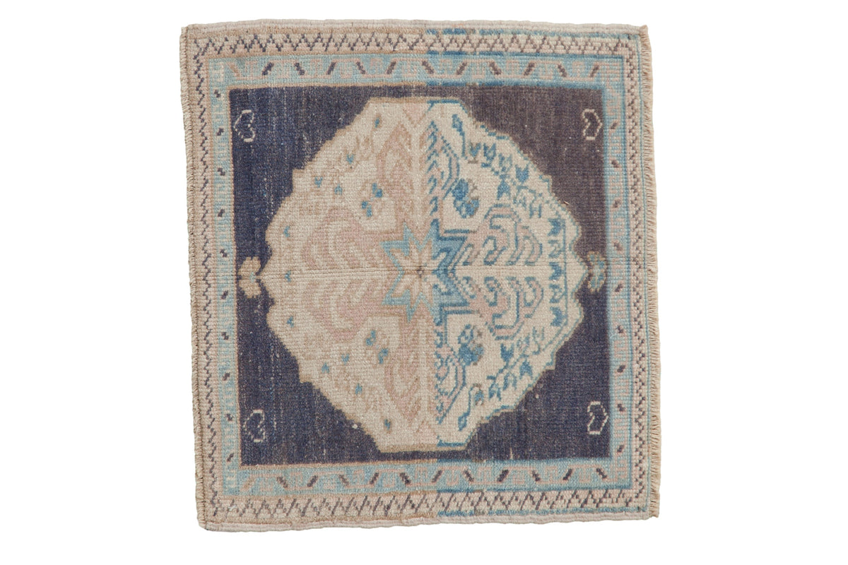 Vintage distressed Oushak square rug with a split-color medallion in rose and blue on a navy ground.