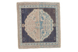 Vintage distressed Oushak square rug with a split-color medallion in rose and blue on a navy ground.