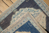 Hand-knotted foundation and secured side selvage on a distressed vintage Oushak rug mat.