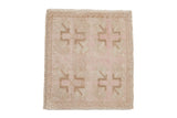 Vintage distressed Oushak square mat with a geometric pattern in soft dusty rose and sand tones.