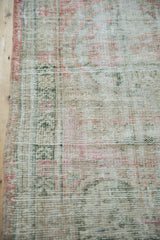 Intact side cord selvage on a distressed Oushak rug, showing the worn, low-pile texture.
