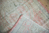 Hand-knotted foundation and blush side cord on the folded corner of a vintage Oushak rug.