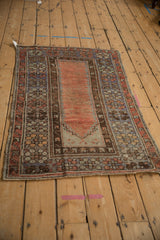 Distressed side of Vintage Melas rug, showing intact selvage and geometric main border.
