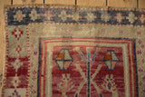 Geometric finned blossom motif with distressed pile in black cherry red and ivory.