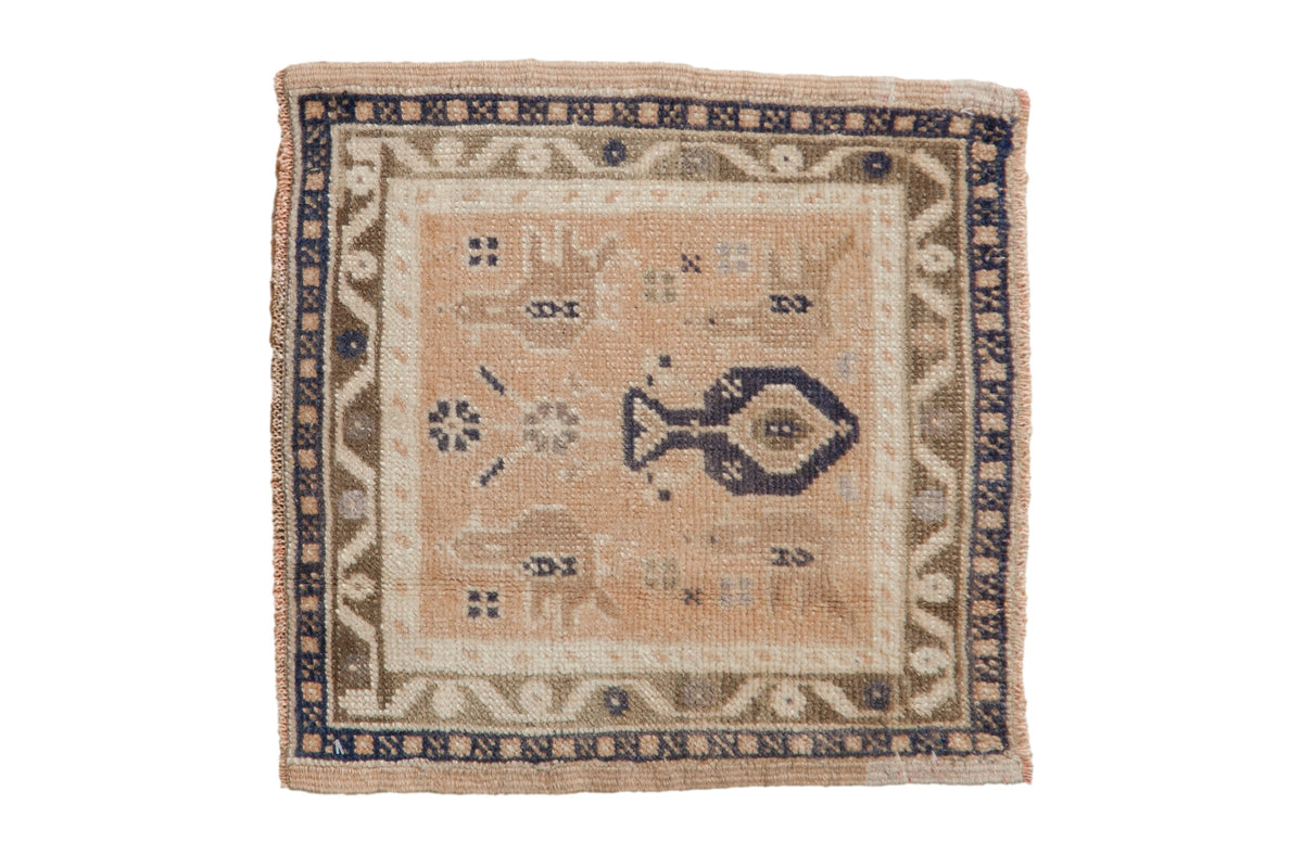 Vintage distressed Oushak square rug with a potted plant motif in pale peach, ivory, and dusty bronze.