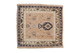 Vintage distressed Oushak square rug with a potted plant motif in pale peach, ivory, and dusty bronze.