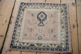 A high-angle view of the square Oushak mat, detailing the full tree of life design against a pale peach field.