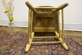Underside of antique primitive stool, weathered wood, chippy paint, visible seat planks.