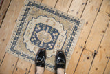 Distressed vintage Oushak rug detail, dusty navy blue, ivory, sand medallion.