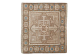 Vintage distressed Oushak square rug with a geometric medallion in coffee brown, ivory, and pops of sky blue.