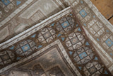 Distressed vintage Oushak rug corner folded to show the evenly worn pile and secured edge.