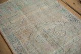 Textured pile of vintage distressed Oushak rug, showing visible foundation, beige and sea foam.