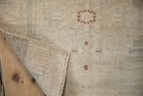 Hand-knotted Turkish Oushak rug's edge showing pile, intact selvage, and woven foundation.