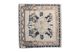 Vintage Oushak square rug with a distressed, geometric navy and ivory medallion on a cream field.