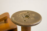 Vintage wooden spool top, showcasing rustic brown patina, industrial screws, and worn texture.
