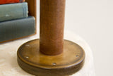 Large Industrial Spool's rustic wooden base with rich patina and fasteners.