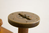 Rustic dark brown vintage industrial spool top with central slot and holes.