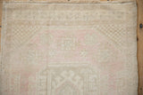 Oushak rug with distressed pile, even wear, and ivory, pink, pale sage green abrashes.