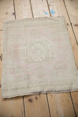 Distressed vintage Oushak rug displaying worn texture and softened ivory, cream, pink abrash.
