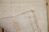 Tightly woven reverse of a Vintage Oushak rug, showing distressed pile with pale pink and sage.