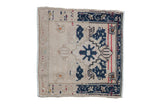 Vintage distressed Oushak square rug with a navy stepped medallion and floral blossoms on a beige field.