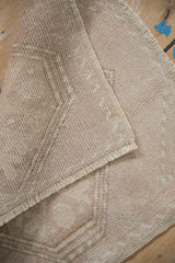 The hand-knotted foundation and intact side cord on the reverse of a vintage Oushak rug.
